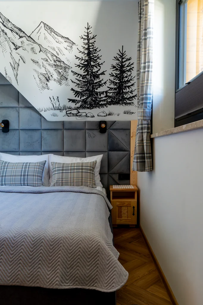 Bedroom with a mountain wall decoration