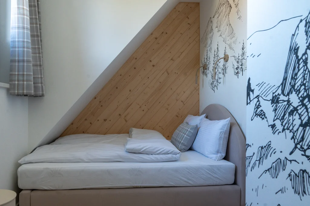 Bed beneath the sloping roof