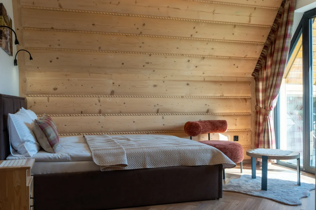 Bedroom with a wooden wall and a large window